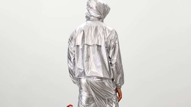 Model wearing metallic tracksuit.